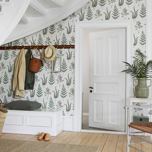 Inspiration for a mid-sized cottage light wood floor entryway remodel in Boston with green walls and a white front door