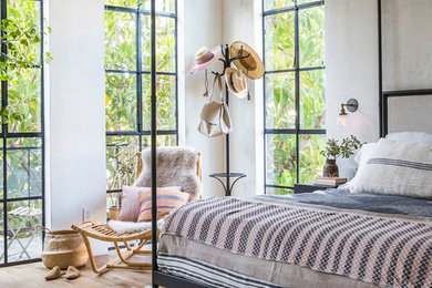 Bedroom - coastal light wood floor bedroom idea in Other with white walls and no fireplace