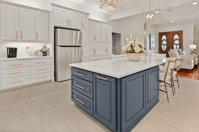 Large transitional u-shaped porcelain tile and gray floor eat-in kitchen photo in New Orleans with an undermount sink, raised-panel cabinets, quartz countertops, white backsplash, quartz backsplash, stainless steel appliances, an island, white countertops and blue cabinets