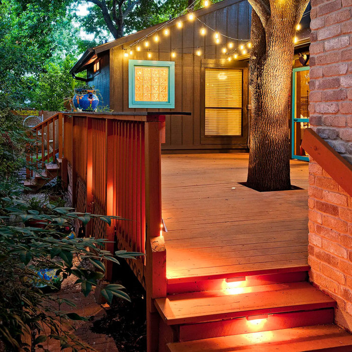 Modern composite deck design with outdoor lighting in Ottawa by Blue Crown Renovations.