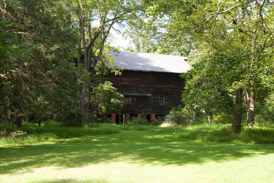 Example of a large mountain style three-story wood exterior home design in New York