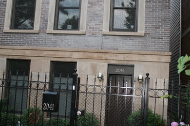 This is an example of a large modern three-storey brick grey exterior in Chicago with a flat roof.