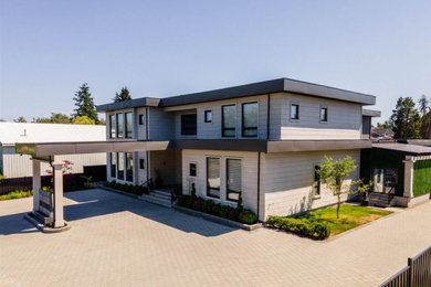 Huge modern two-story stucco exterior home idea in Vancouver