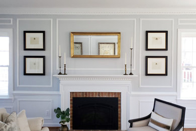 Inspiration for a large timeless formal and enclosed medium tone wood floor and wainscoting living room remodel in DC Metro with gray walls, a standard fireplace and a brick fireplace