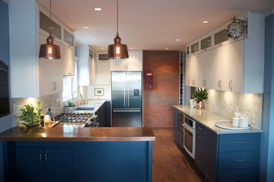 Mid-sized eclectic l-shaped medium tone wood floor and brown floor eat-in kitchen photo in Vancouver with an undermount sink, flat-panel cabinets, blue cabinets, copper countertops, gray backsplash, marble backsplash and a peninsula