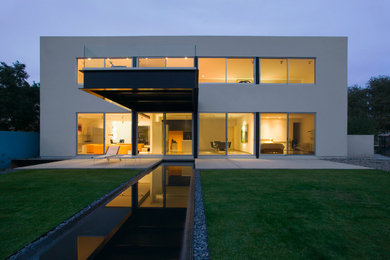 Large trendy white two-story exterior home photo in Phoenix