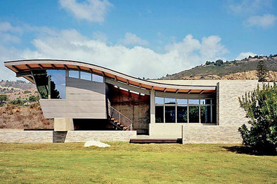Inspiration for a large contemporary beige one-story mixed siding exterior home remodel in Kansas City