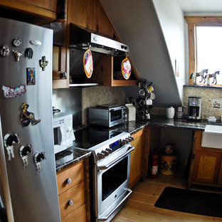 Mid-sized farmhouse kitchen pantry inspiration - Mid-sized cottage l-shaped light wood floor kitchen pantry photo in Albuquerque with a farmhouse sink, granite countertops, beige backsplash, ceramic backsplash, stainless steel appliances, recessed-panel cabinets, medium tone wood cabinets and no island