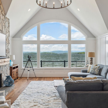 Lakefront Living Room with Vaulted Ceilings and Stone Fireplace