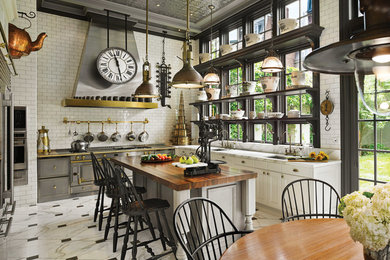 Eat-in kitchen - large industrial u-shaped marble floor and white floor eat-in kitchen idea in Minneapolis with shaker cabinets, white cabinets, white backsplash, subway tile backsplash, stainless steel appliances and an island