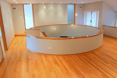 Foyer - large contemporary light wood floor foyer idea in Chicago with white walls