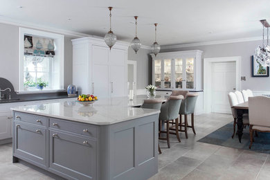 Design ideas for an expansive traditional l-shaped open plan kitchen in Other with an integrated sink, shaker cabinets, grey cabinets, marble worktops, white splashback, ceramic splashback, black appliances, ceramic flooring, an island and grey floors.