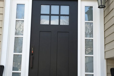 Photo of an entryway in New York with a single front door and a black front door.
