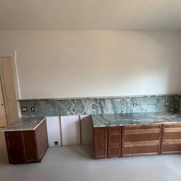 Green quartzite kitchen with full-height slab backsplash