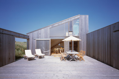 This is an example of a mid-sized scandinavian side yard deck in Aarhus with no cover.
