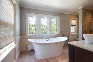 Mid-sized transitional master bathroom in Boston with furniture-like cabinets, dark wood cabinets, engineered quartz benchtops, a freestanding tub, beige tile and porcelain tile.