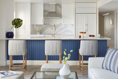 Inspiration for a mid-sized coastal galley porcelain tile, gray floor and shiplap ceiling open concept kitchen remodel with an undermount sink, shaker cabinets, white cabinets, quartz countertops, beige backsplash, quartz backsplash, paneled appliances, a peninsula and beige countertops