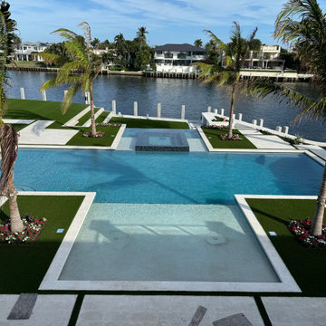 Waterfront Luxury: A Modern Pool and Turf Oasis