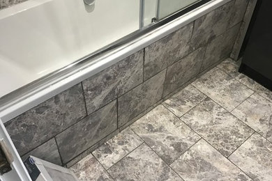 Design ideas for a small modern family bathroom in London with a built-in bath, a built-in shower, grey tiles, porcelain tiles, porcelain flooring, grey floors and a sliding door.
