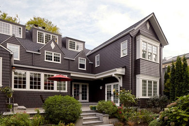 Example of a classic gray two-story exterior home design in Seattle with a shingle roof