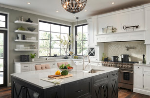 Example of a transitional dark wood floor and brown floor kitchen design in Chicago with an undermount sink, an island, recessed-panel cabinets, white cabinets, beige backsplash, mosaic tile backsplash, stainless steel appliances and white countertops