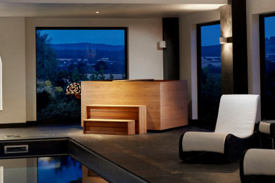 Large trendy indoor tile and custom-shaped natural hot tub photo in Other