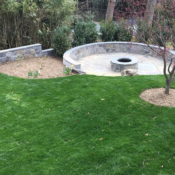 Irregular flagstone patio, stone sitting wall, stone firepit
