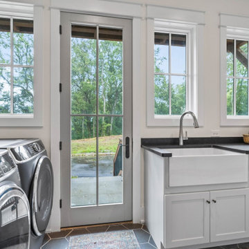Bright Modern Farmhouse Laundry Room: Farmhouse Sink, Front-Load Appliances, and