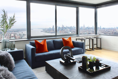 Mid-sized trendy formal and open concept medium tone wood floor living room photo in New York with white walls, no fireplace and no tv