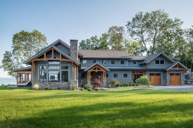 Huge arts and crafts blue two-story concrete fiberboard and clapboard exterior home photo in New York with a mixed material roof and a brown roof