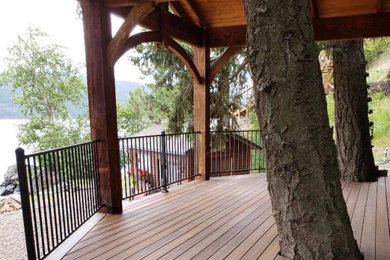Example of a deck design in Other with a roof extension