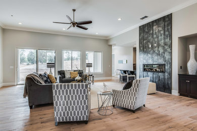 This is an example of a large contemporary formal open concept living room in Sacramento with grey walls, light hardwood floors, a ribbon fireplace, a tile fireplace surround, no tv and beige floor.