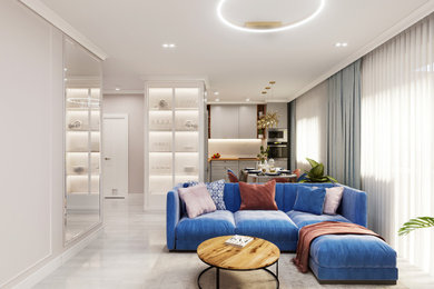 Идея дизайна: гостиная комната с полом из ламината, телевизором на стене и синим диваном