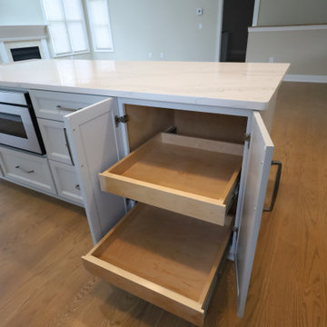 Sleek & Sophisticated: Gray Kitchen Remodel with Quartz Countertops, Marble Back
