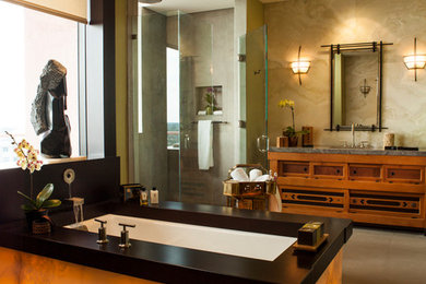 Large zen master beige tile and marble tile limestone floor and beige floor corner shower photo in Miami with recessed-panel cabinets, medium tone wood cabinets, an undermount tub, beige walls, an undermount sink, marble countertops and a hinged shower door