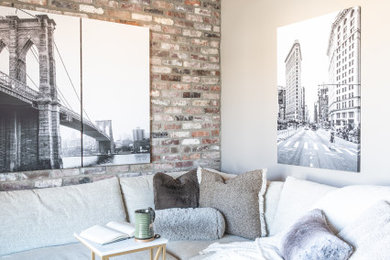 Living room - mid-sized industrial enclosed light wood floor, wood ceiling and brick wall living room idea in Little Rock with beige walls
