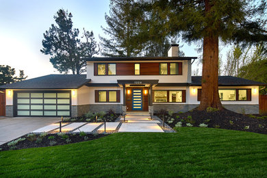 Example of a mid-sized trendy white two-story mixed siding house exterior design in San Francisco with a shed roof and a shingle roof