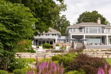Huge transitional blue wood house exterior idea in Milwaukee