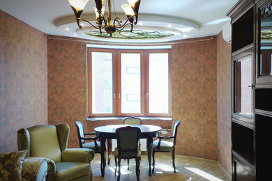 This is an example of a mid-sized traditional formal enclosed living room in Saint Petersburg with multi-coloured walls, medium hardwood floors, no fireplace, a wall-mounted tv and beige floor.