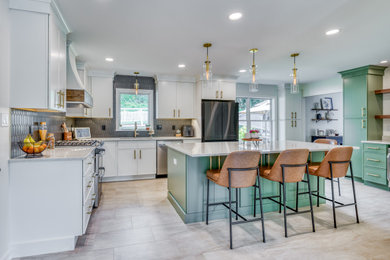 Eat-in kitchen - large transitional laminate floor and beige floor eat-in kitchen idea in Other with shaker cabinets, quartz countertops, black backsplash, ceramic backsplash, stainless steel appliances, an island and white countertops