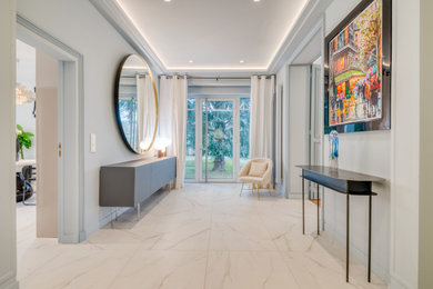 Design ideas for an expansive modern foyer in Paris with blue walls, ceramic floors, a single front door, a metal front door and white floor.