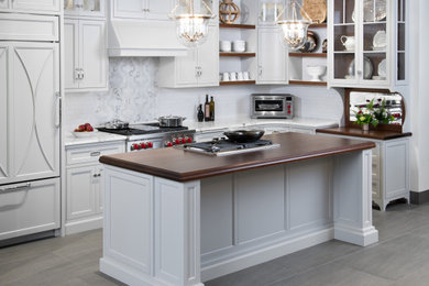 Example of a mid-sized l-shaped kitchen design in Boston with an island