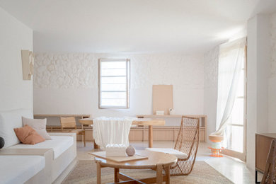 This is an example of a medium sized country open plan living room feature wall in Other with a reading nook, white walls, limestone flooring, no fireplace, no tv and beige floors.