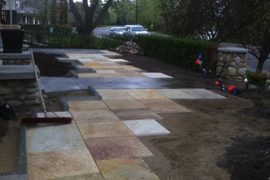 Patio - mid-sized modern courtyard stone patio idea in Calgary