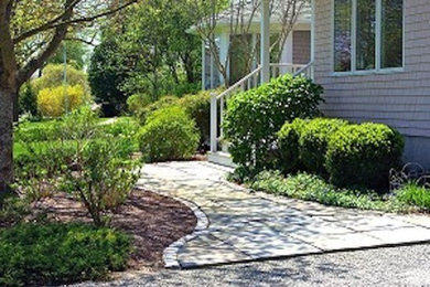 Photo of a mid-sized traditional partial sun front yard stone garden path in Providence.