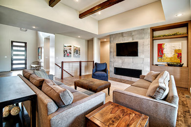 Inspiration for a large timeless open concept dark wood floor living room remodel in Other with gray walls, a standard fireplace, a tile fireplace and a wall-mounted tv
