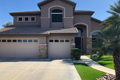 Minimalist two-story stucco exterior home photo in Phoenix with a tile roof