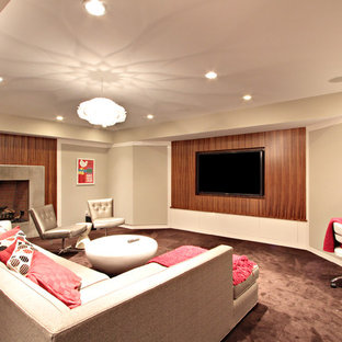 ニューヨークのコンテンポラリースタイルのおしゃれな地下室 (コンクリートの暖炉まわり、標準型暖炉、カーペット敷き、全地下、ベージュの壁、茶色い床) の写真