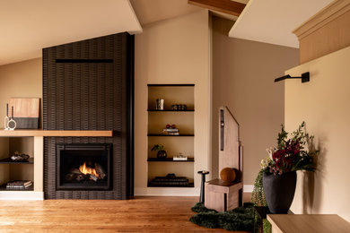 Large trendy formal and open concept medium tone wood floor, brown floor, exposed beam and wall paneling living room photo in Chicago with beige walls, a wood stove, a tile fireplace and no tv