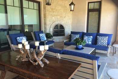Inspiration for a large coastal courtyard tile patio remodel in San Diego with a fire pit and a roof extension